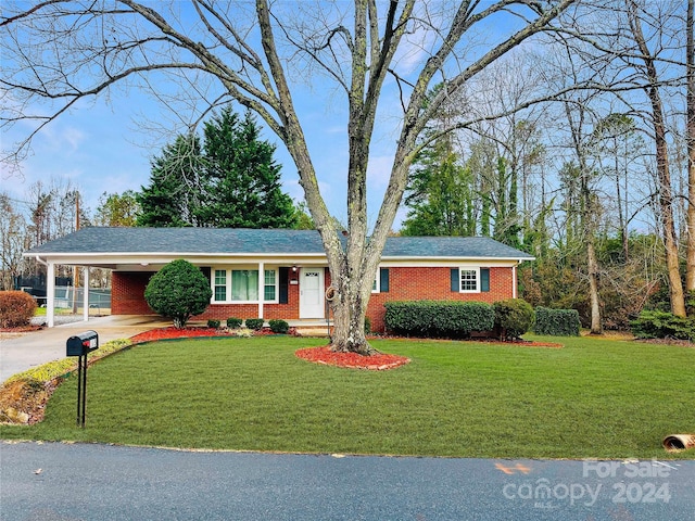 ranch-style home with a front yard and a carport