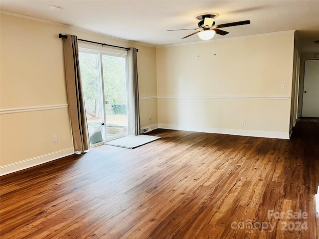 spare room featuring ceiling fan, wood-type flooring, and ornamental molding