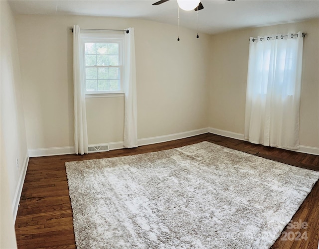 unfurnished room with ceiling fan and dark hardwood / wood-style floors