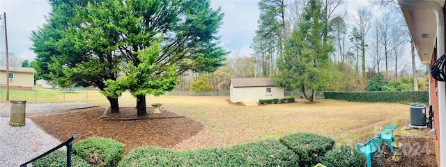 view of yard with cooling unit and a storage unit