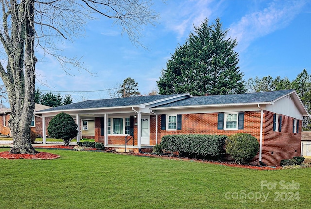 ranch-style house with covered porch and a front yard