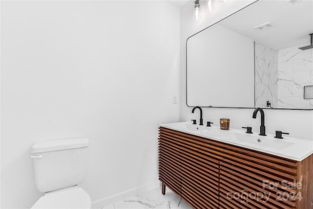 bathroom featuring a shower, vanity, and toilet