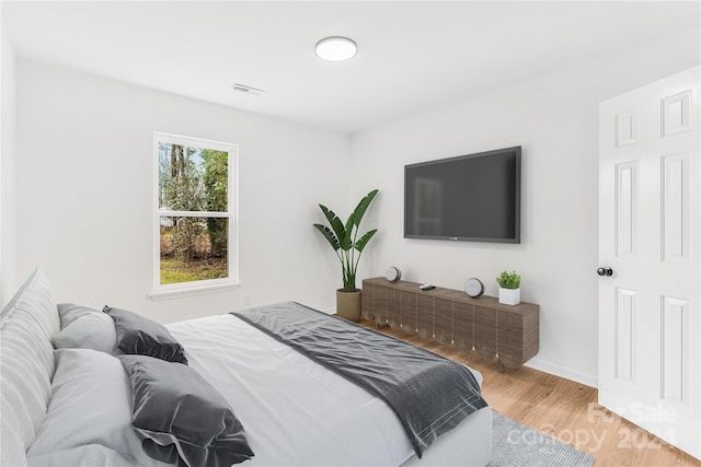 bedroom with wood-type flooring