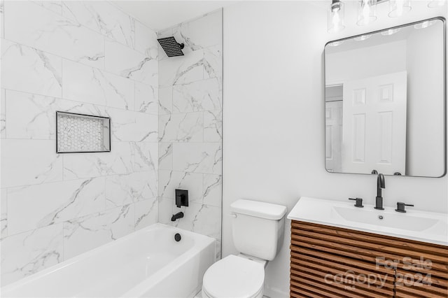 full bathroom featuring vanity, tiled shower / bath combo, and toilet