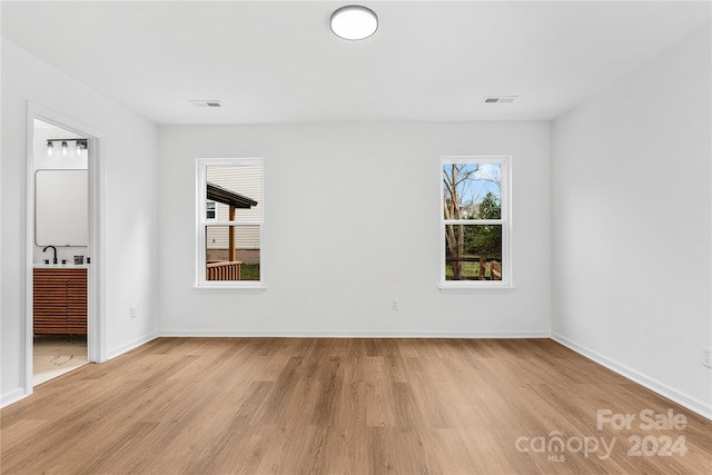 unfurnished bedroom with light wood-type flooring and sink