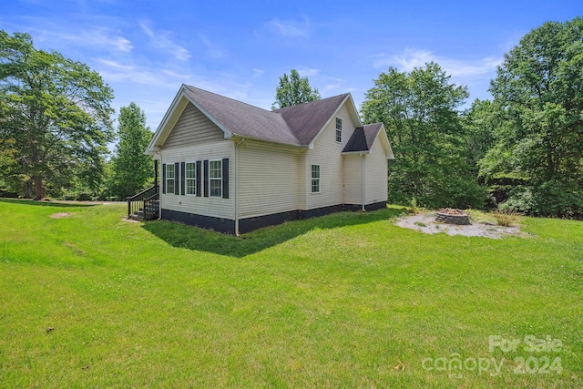 view of side of property with a lawn