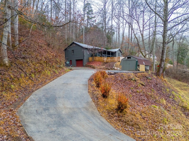 single story home featuring a garage and a storage unit