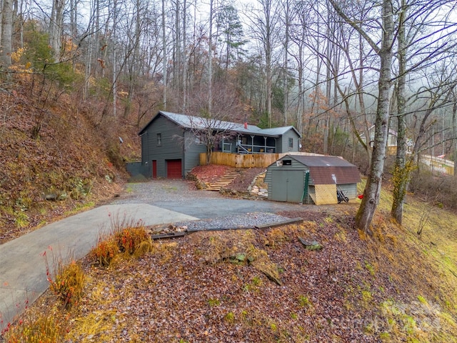 exterior space featuring a storage shed and a wooden deck