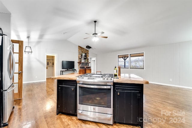 kitchen featuring a center island, vaulted ceiling, light hardwood / wood-style flooring, ceiling fan, and appliances with stainless steel finishes