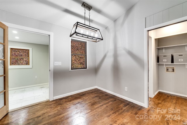 unfurnished dining area featuring dark wood-type flooring