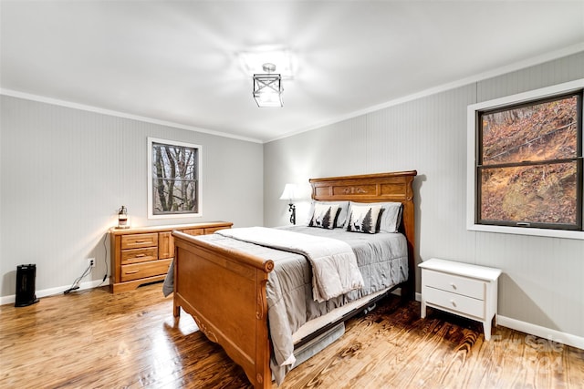 bedroom featuring hardwood / wood-style floors and ornamental molding