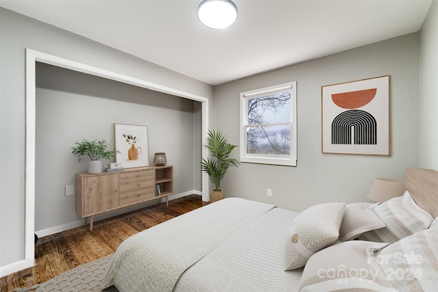 bedroom with dark hardwood / wood-style floors