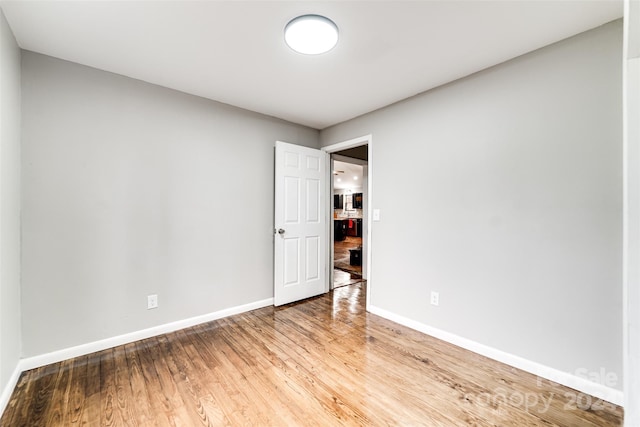 unfurnished room featuring hardwood / wood-style flooring