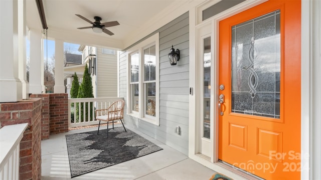 doorway to property featuring covered porch and ceiling fan