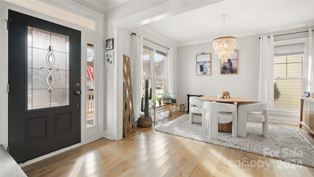 foyer featuring a chandelier and light hardwood / wood-style flooring