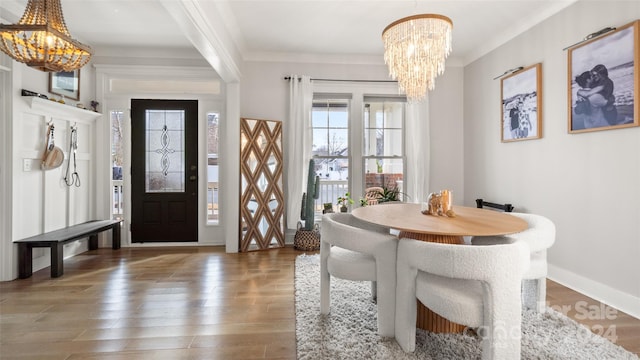 dining room with dark hardwood / wood-style flooring, crown molding, and a notable chandelier