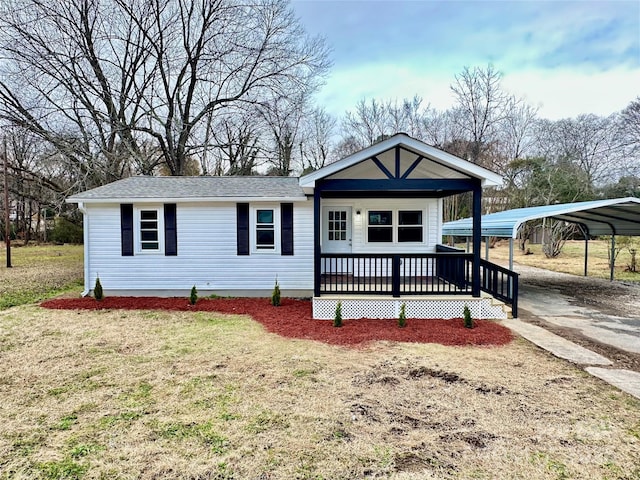 view of front facade with a carport and a front yard