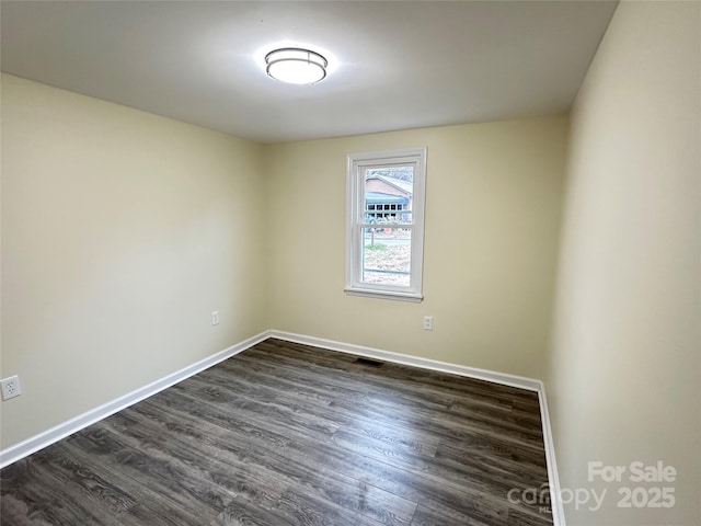 empty room with dark hardwood / wood-style floors