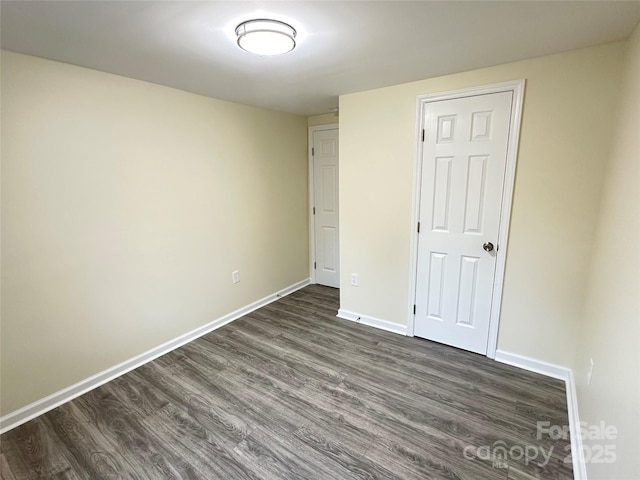 unfurnished bedroom with dark hardwood / wood-style floors