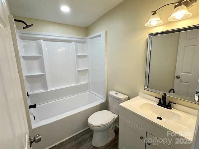 full bathroom featuring hardwood / wood-style flooring, vanity, toilet, and washtub / shower combination