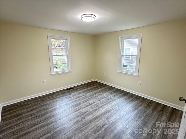 unfurnished room featuring dark hardwood / wood-style flooring