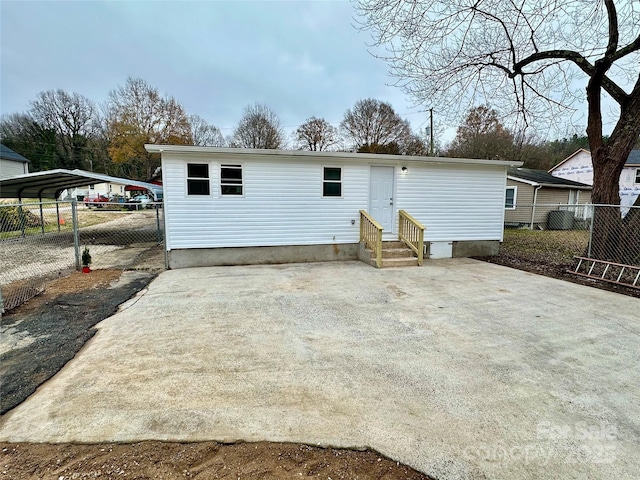 back of property with a carport