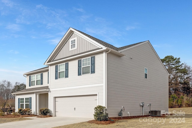 view of home's exterior with central AC and a garage