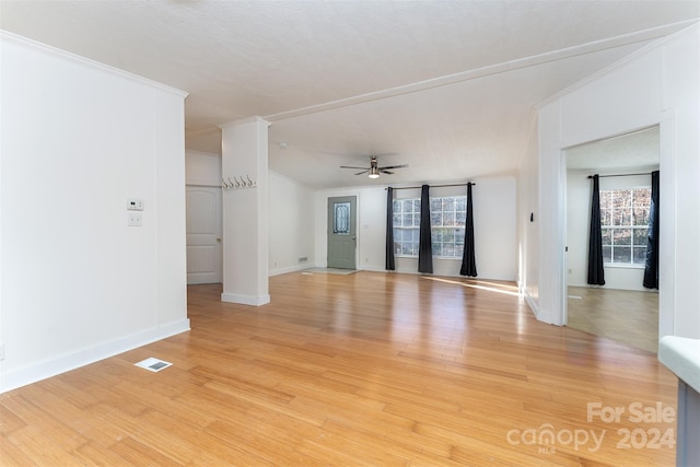 unfurnished room featuring light wood-type flooring, ceiling fan, and ornamental molding