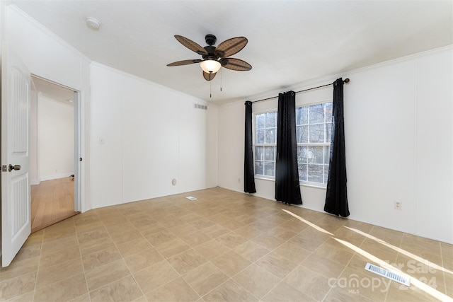 empty room with ceiling fan and crown molding