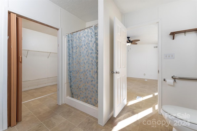 bathroom featuring ceiling fan, toilet, tile patterned flooring, and a shower with shower curtain