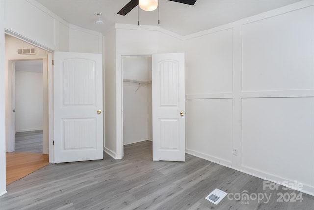 unfurnished bedroom featuring ceiling fan, a closet, and light hardwood / wood-style flooring