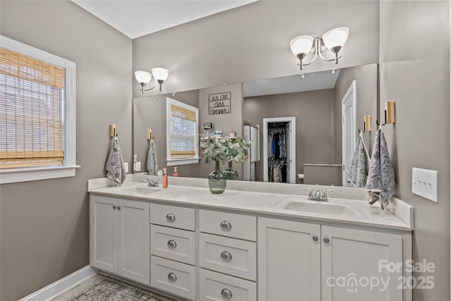 bathroom with a notable chandelier and vanity