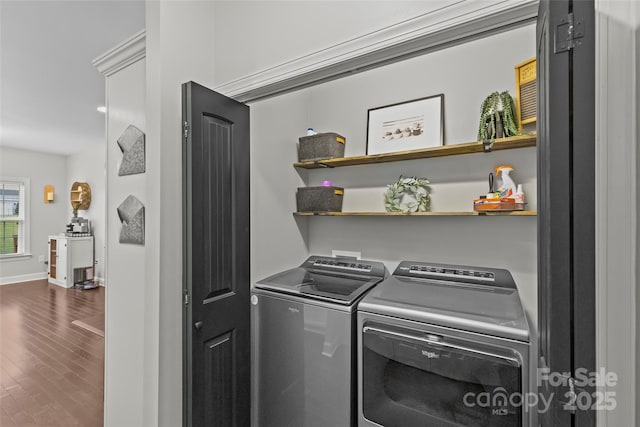 washroom featuring hardwood / wood-style floors and washer and dryer