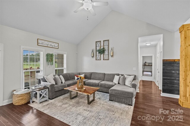 living room with hardwood / wood-style floors, ceiling fan, and high vaulted ceiling