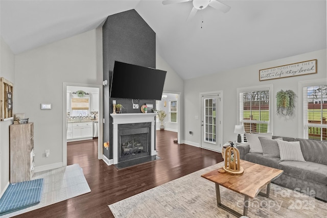 living room with ceiling fan, sink, high vaulted ceiling, and dark wood-type flooring