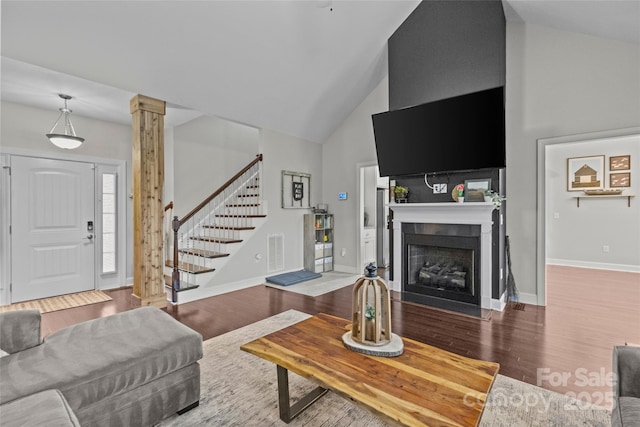 living room with high vaulted ceiling and hardwood / wood-style flooring