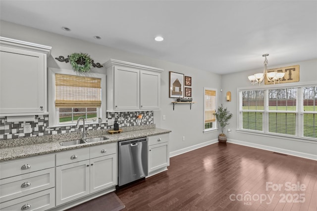 kitchen with dishwasher, decorative backsplash, white cabinetry, and sink