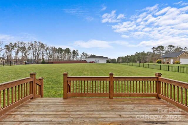 wooden deck featuring a lawn and a rural view