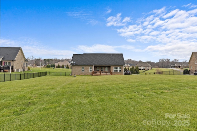 back of house featuring a lawn