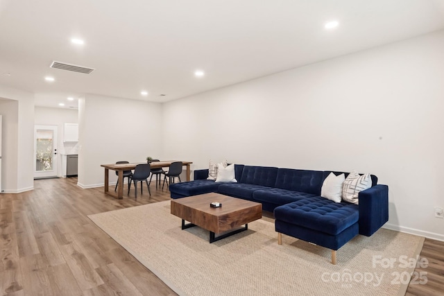 living room with light hardwood / wood-style flooring