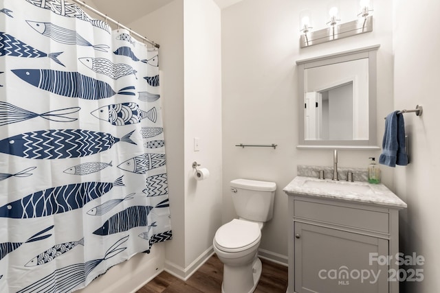 full bathroom with vanity, hardwood / wood-style flooring, toilet, and shower / bath combo with shower curtain