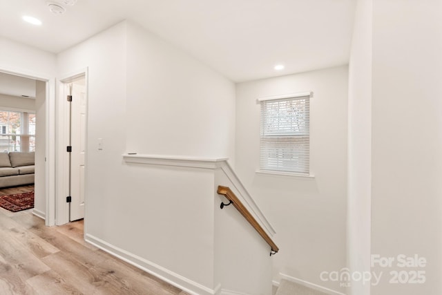 stairs featuring hardwood / wood-style floors