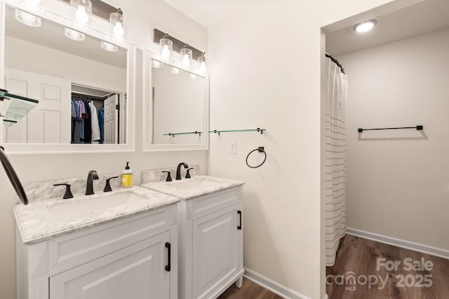 bathroom with hardwood / wood-style floors, vanity, and a shower with curtain