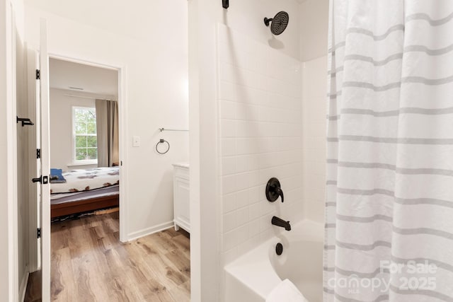 bathroom featuring hardwood / wood-style flooring and shower / tub combo with curtain