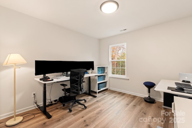 office area with light hardwood / wood-style floors