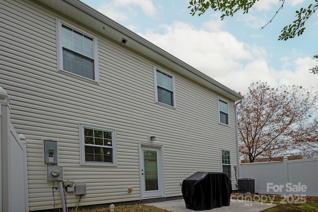 back of house featuring central AC unit and a patio area