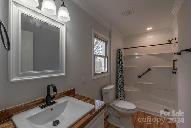 bathroom featuring crown molding, toilet, hardwood / wood-style flooring, and walk in shower