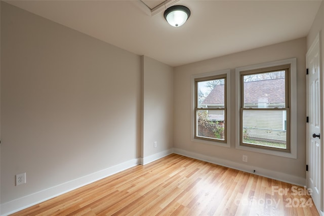 unfurnished room with light wood-type flooring