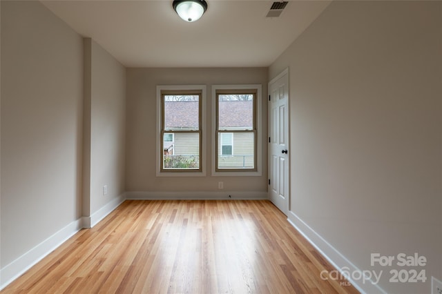 empty room with light hardwood / wood-style flooring