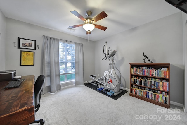 carpeted office featuring ceiling fan